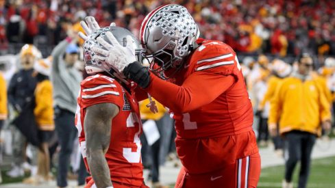 Ohio State players Tegra Tshabola and TreVeyon Henderson celebrate a touchdown