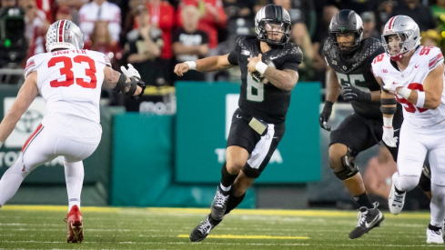 Dillon Gabriel running away from Jack Sawyer and Caden Curry