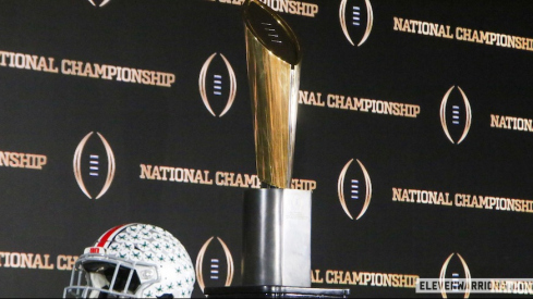 Ohio State helmet with College Football Playoff trophy