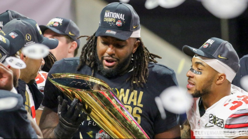 Donovan Jackson holding the College Football Playoff champions