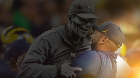 Michigan offensive coordinator Sherrone Moore picks up head coach Jim Harbaugh after they won the College Football Playoff national championship game against Washington at NRG Stadium in Houston, Texas on Monday, January 8, 2024.