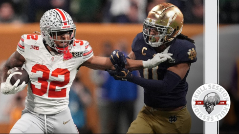 TreVeyon Henderson stiff arms a Notre Dame defender