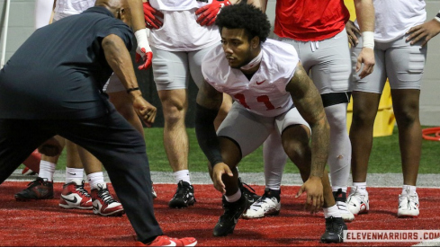 C.J. Hicks going through a drill with Larry Johnson