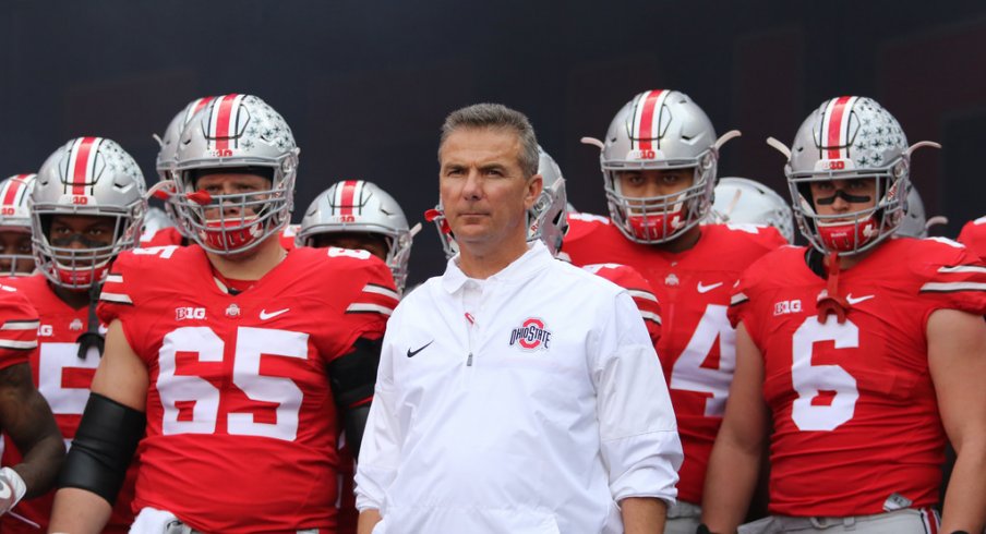 Urban Meyer leads Ohio State onto the field vs. Northwestern. 