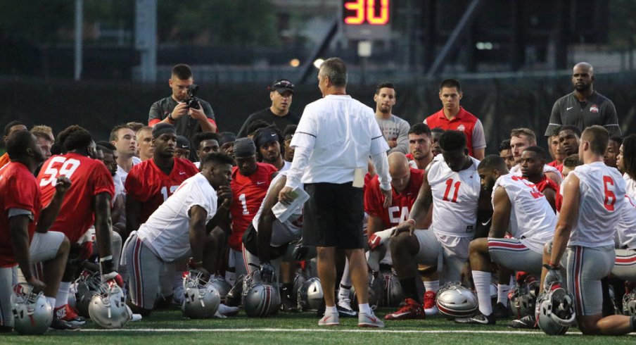 Urban Meyer talks to his team during its first preseason practice on July 27.