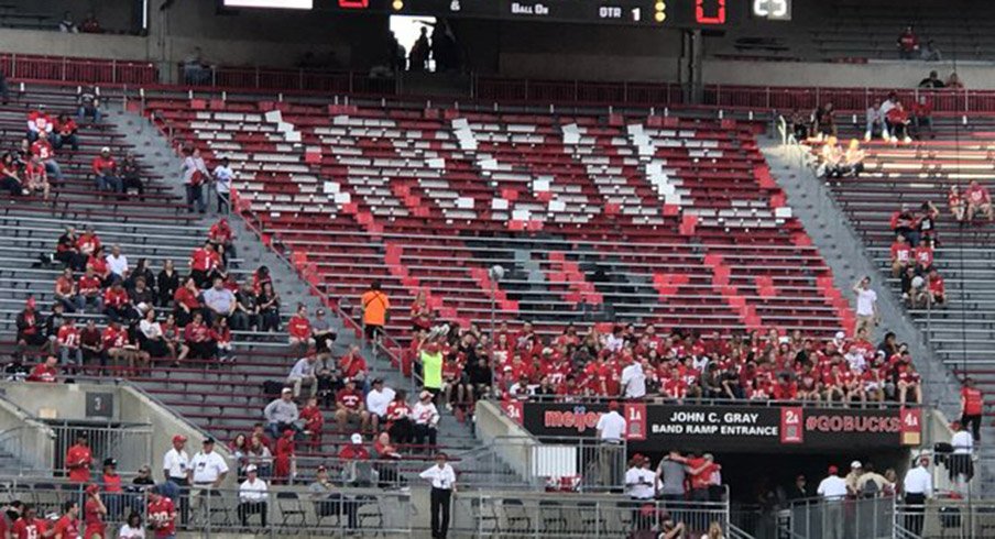 Block O has cards ready to spell “BASIC” for Oklahoma quarterback Baker Mayfield