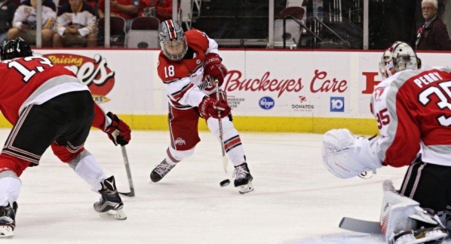 Ohio State's Christian Lampasso locks sights on Rensselaer goalie Chase Perry.