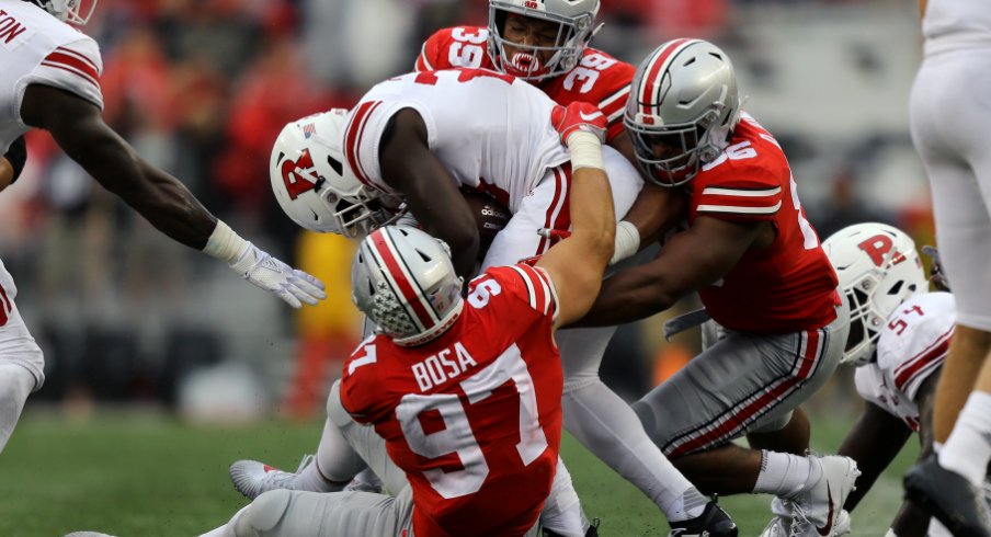 Rutgers running back Jonathan Hilliman (23) is tackled by Ohio State's Nick Bosa (97), Javontae Jean-Baptiste (38), and Dre'Mont Jones (86) in the first half at Ohio Stadium.