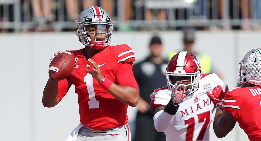 Justin Fields of the Ohio State Buckeyes looks on in the first