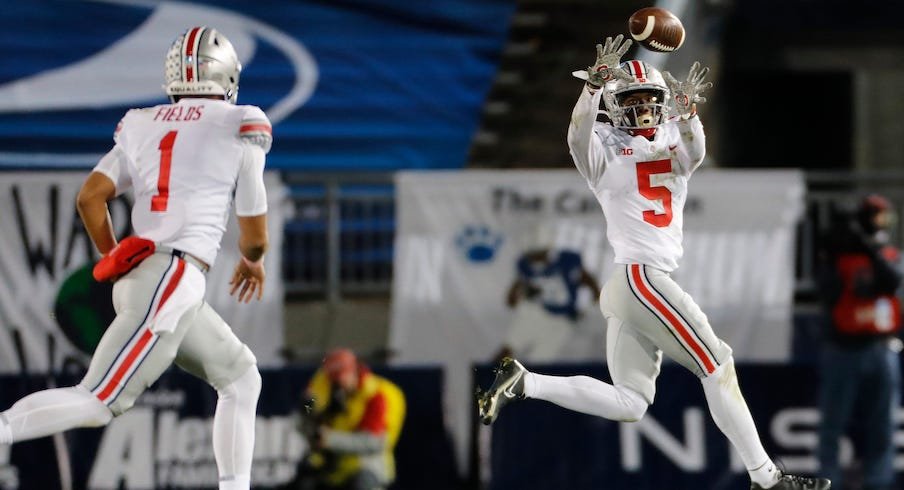 Justin Fields of the Ohio State Buckeyes looks on in the first half