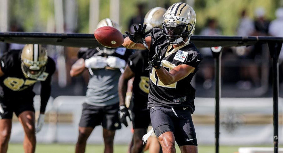 Chris Olave & Michael Thomas New Orleans Saints Unsigned Embracing in White Jerseys Photograph