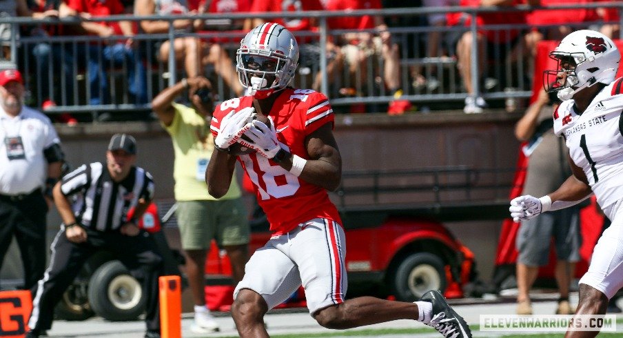 Ohio State wide receiver Marvin Harrison, Jr. runs after a catch