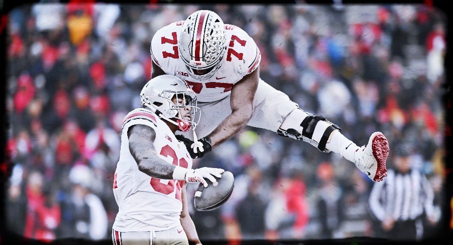 Nov 19, 2022; College Park, Maryland, USA; Ohio State Buckeyes running back TreVeyon Henderson (32) celebrates with offensive lineman Paris Johnson Jr. (77) after scoring a first quarter touchdown against the Maryland Terrapins at SECU Stadium. 