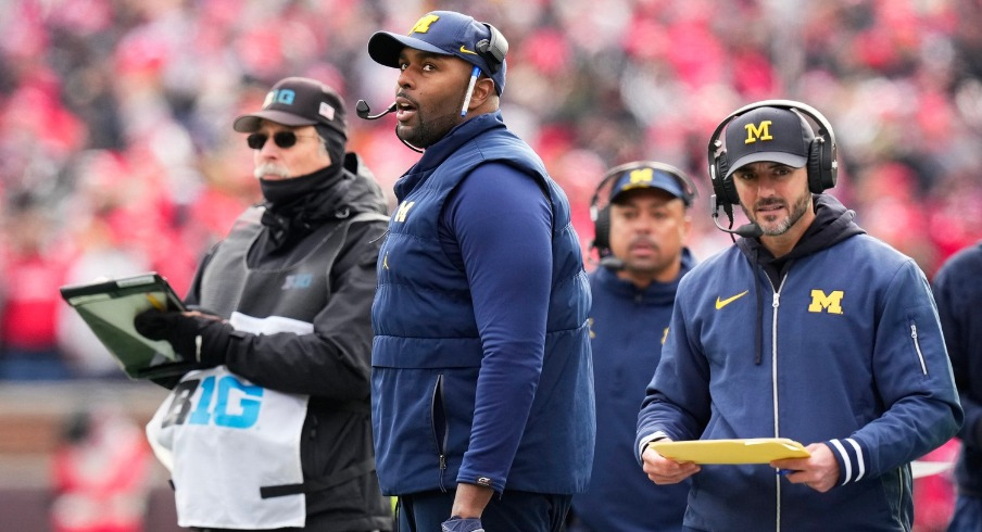 Michigan interim head coach Sherrone Moore (left) and defensive coordinator Jesse Minter