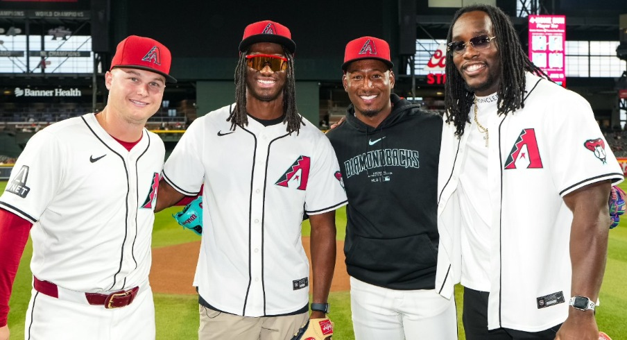 Arizona Cardinals wide receiver Marvin Harrison Jr. (left center) throws out first pitch for the Arizona Diamondbacks