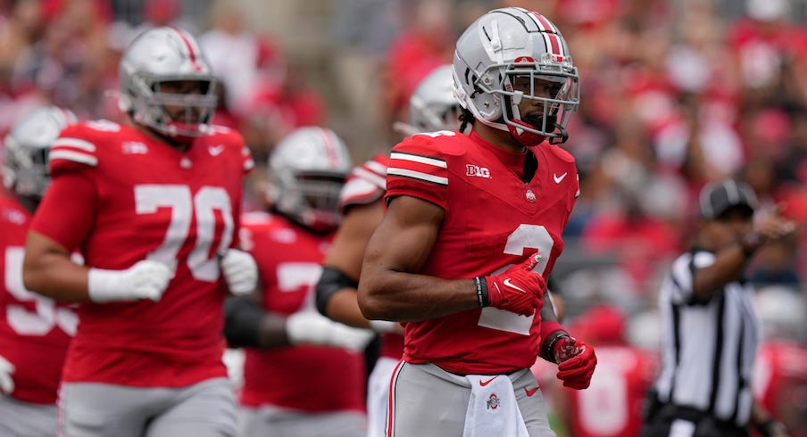 Emeka Egbuka leading Ohio State players out of the tunnel in 2023