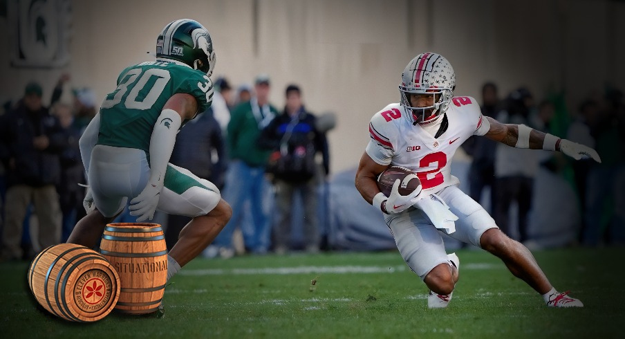 Oct 8, 2022; East Lansing, Michigan, USA; Ohio State Buckeyes wide receiver Emeka Egbuka (2) heads up field after a catch against Michigan State Spartans cornerback Justin White (30) in the second quarter of the NCAA Division I football game between the Ohio State Buckeyes and Michigan State Spartans at Spartan Stadium.