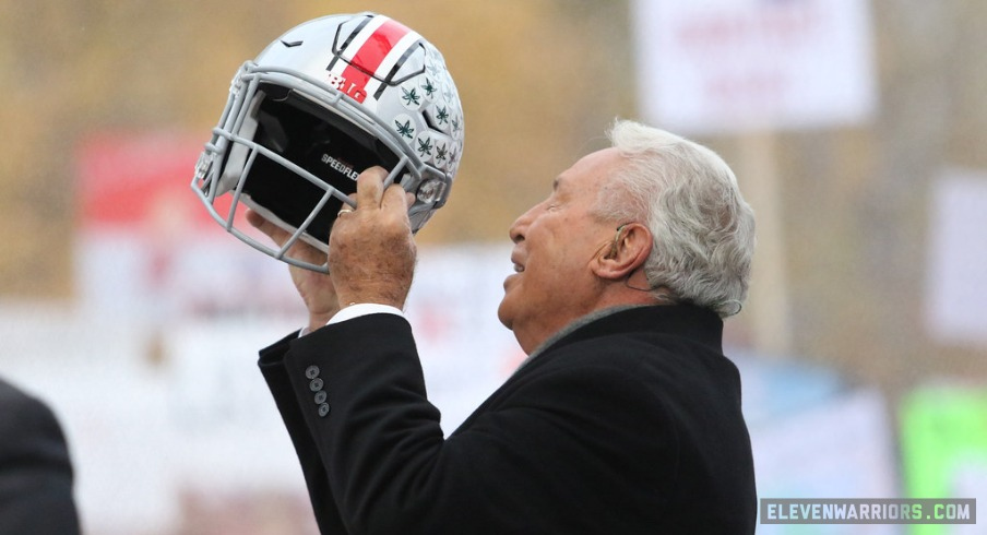 Lee Corso lifts Ohio State helmet on the set of ESPN's College GameDay