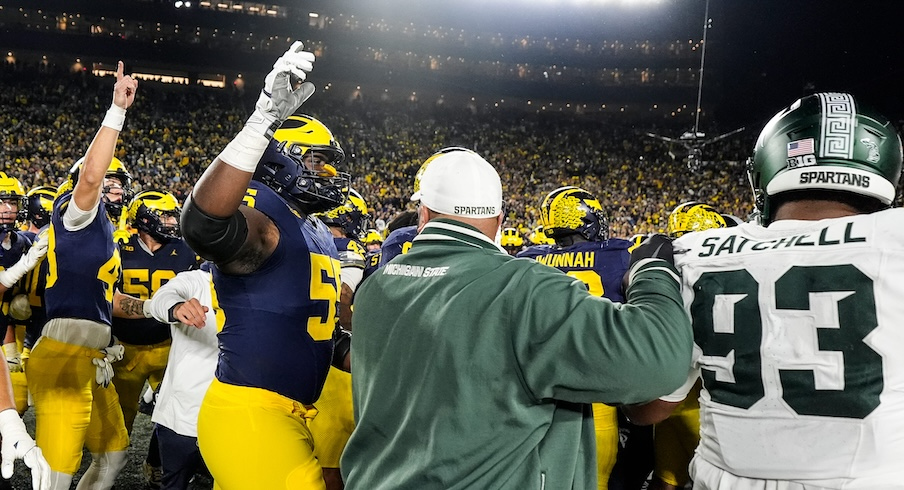 Michigan and Michigan State players get into scuffle to end the game.