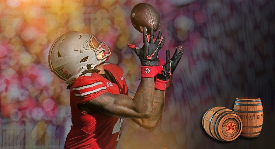 Ohio State Buckeyes wide receiver Jeremiah Smith (4) catches a touchdown pass in front of Nebraska Cornhuskers defensive back Isaac Gifford (2) during the first half of the NCAA football game at Ohio Stadium in Columbus on Saturday, Oct. 26, 2024.