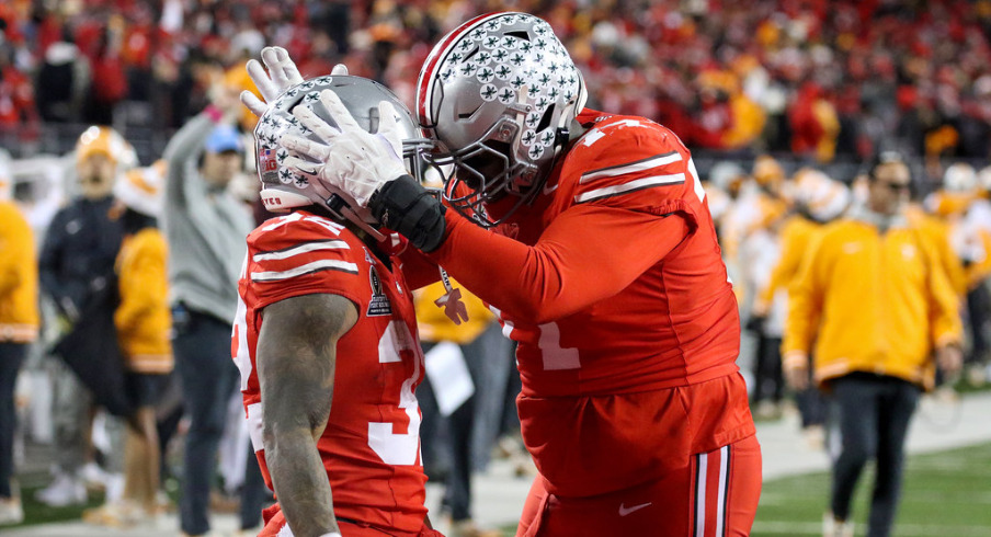 Ohio State players Tegra Tshabola and TreVeyon Henderson celebrate a touchdown