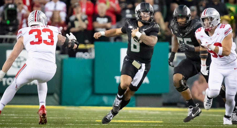 Dillon Gabriel running away from Jack Sawyer and Caden Curry