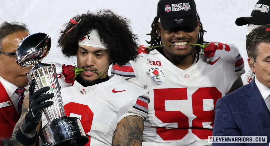 Lathan Ransom and Ty Hamilton celebrate Ohio State's 41-21 Rose Bowl Game victory over Oregon with the Leishman Trophy