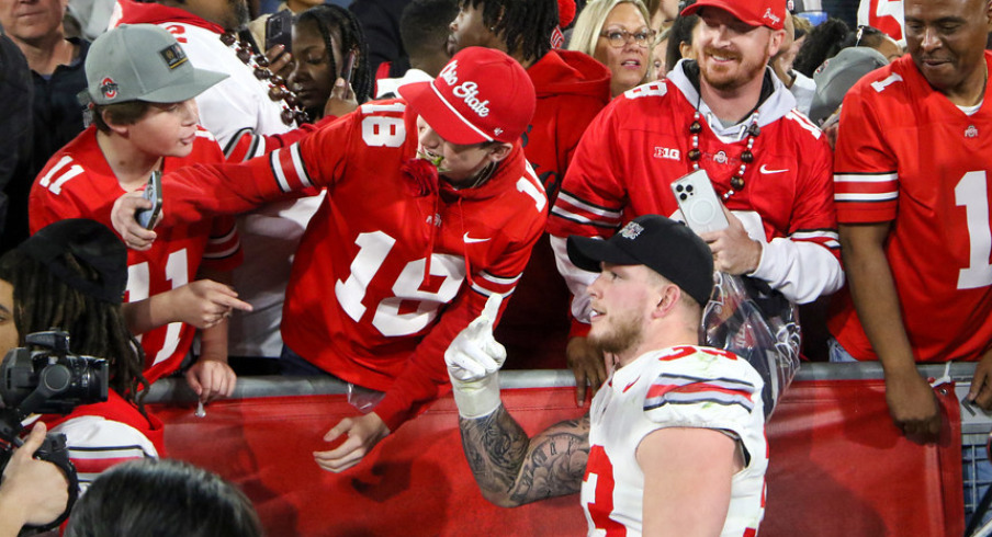 Ohio State defensive lineman Jack Sawyer celebrates with a fan