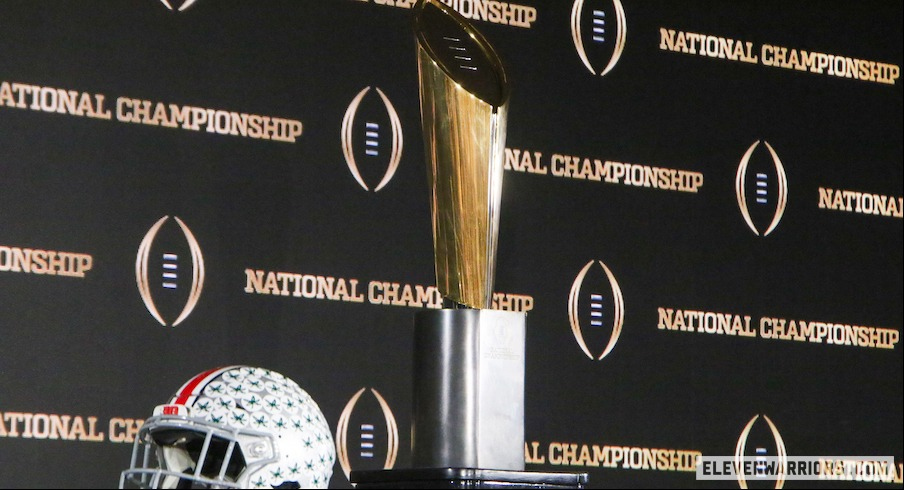 Ohio State helmet with College Football Playoff trophy