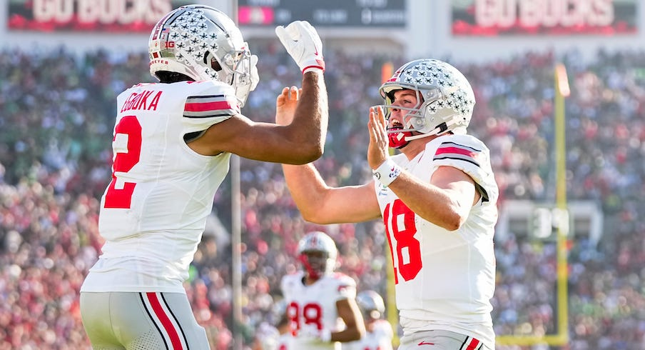 Emeka Egbuka celebrating with Will Howard