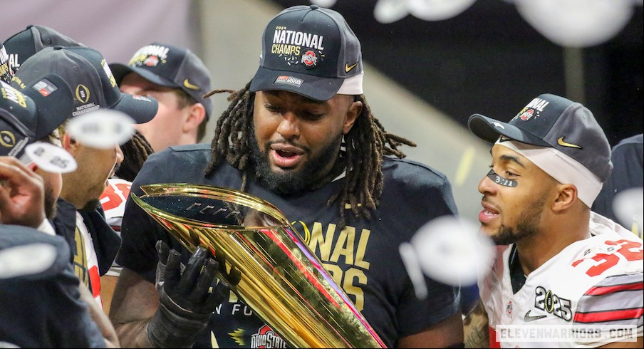 Donovan Jackson holding the College Football Playoff champions