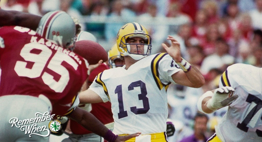 LSU Tigers quarterback Tommy Hodson (13) sets to throw the ball against the Ohio State Buckeyes at Ohio Stadium.